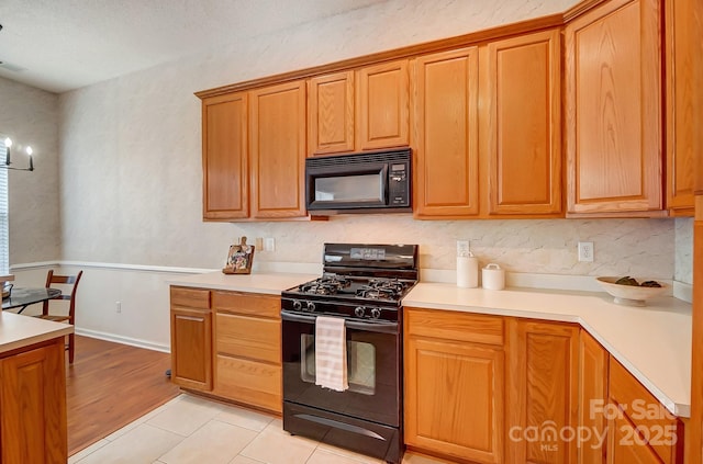 kitchen with light tile patterned floors and black appliances