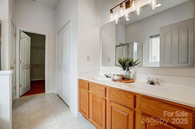 bathroom featuring walk in shower, tile patterned flooring, and vanity