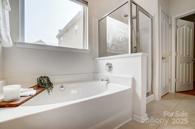 bathroom featuring tile patterned flooring and independent shower and bath