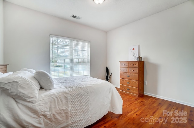 bedroom with hardwood / wood-style flooring