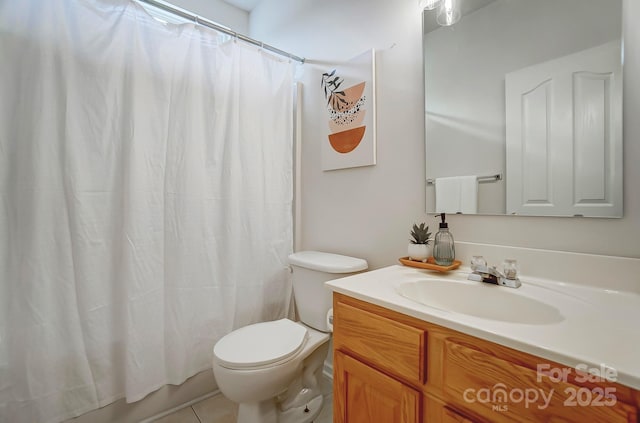 bathroom featuring vanity, tile patterned flooring, toilet, and walk in shower