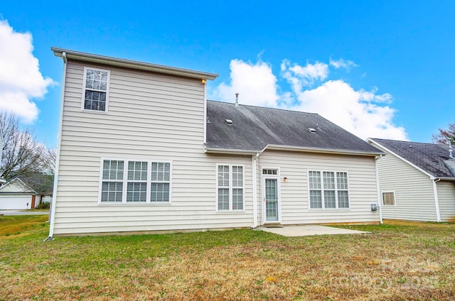 rear view of property featuring a patio and a yard