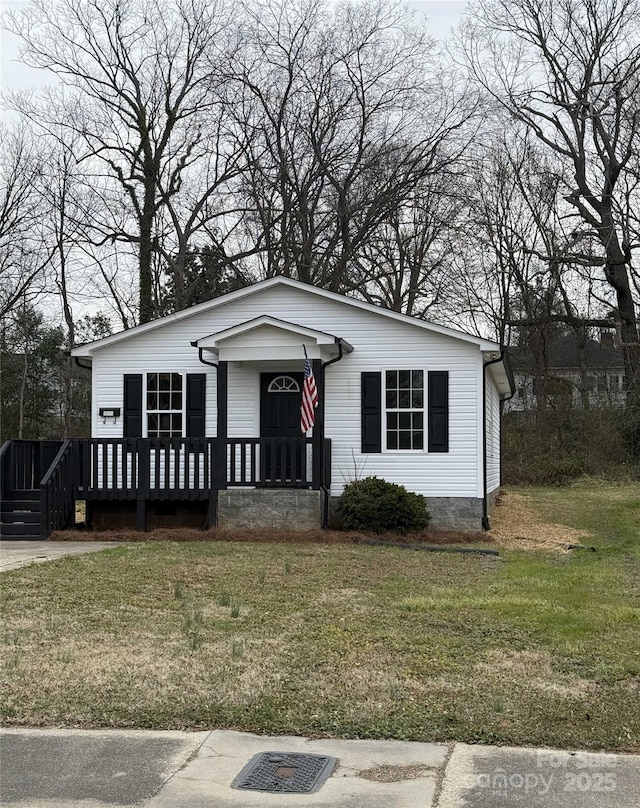 view of front of house featuring a front yard and a deck