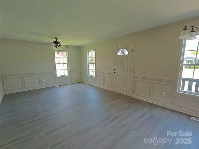 629 S Caldwell St, Salisbury, NC 28144 - entryway with a decorative wall, ceiling fan, wood finished floors, and wainscoting