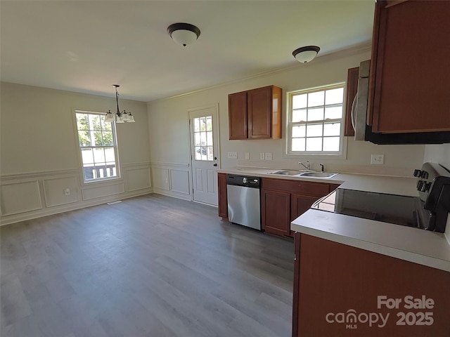 629 S Caldwell St, Salisbury, NC 28144 - kitchen featuring appliances with stainless steel finishes, plenty of natural light, a chandelier, light countertops, and a decorative wall
