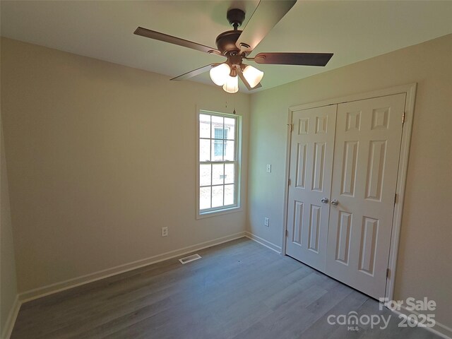 629 S Caldwell St, Salisbury, NC 28144 - unfurnished bedroom featuring wood finished floors, a closet, and a ceiling fan
