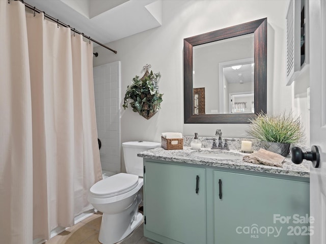 bathroom with tile patterned flooring, vanity, and toilet