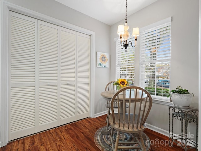 interior space with a notable chandelier and dark hardwood / wood-style flooring