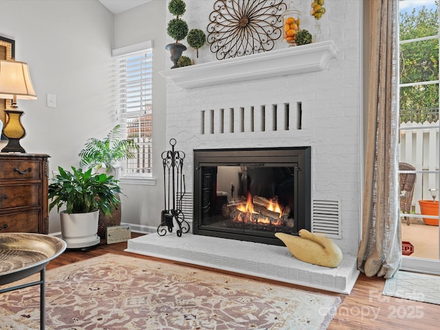 interior details with hardwood / wood-style floors and a fireplace