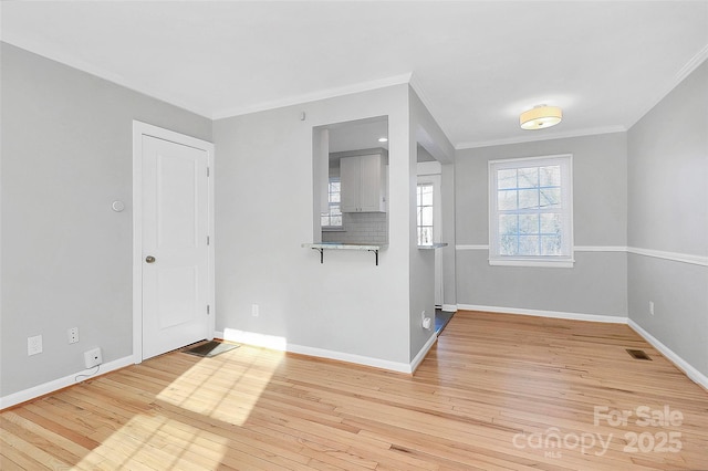 interior space with ornamental molding and light wood-type flooring