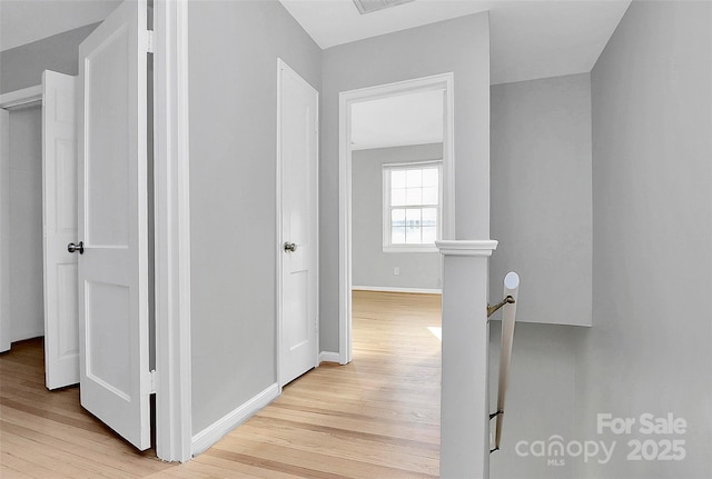 hallway with light hardwood / wood-style flooring