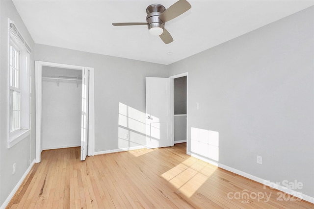 unfurnished bedroom featuring light wood-type flooring, ceiling fan, and a closet