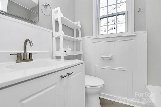 bathroom featuring tile patterned floors, vanity, and toilet