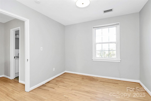 spare room featuring light hardwood / wood-style flooring