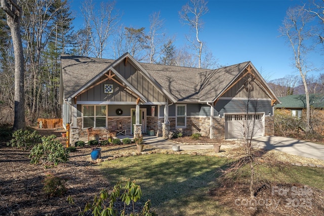 craftsman inspired home with a garage, a porch, and a front lawn