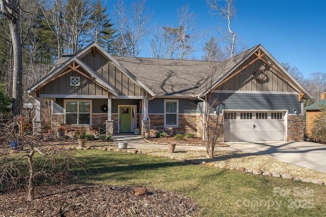 craftsman-style house with a garage, covered porch, and a front yard