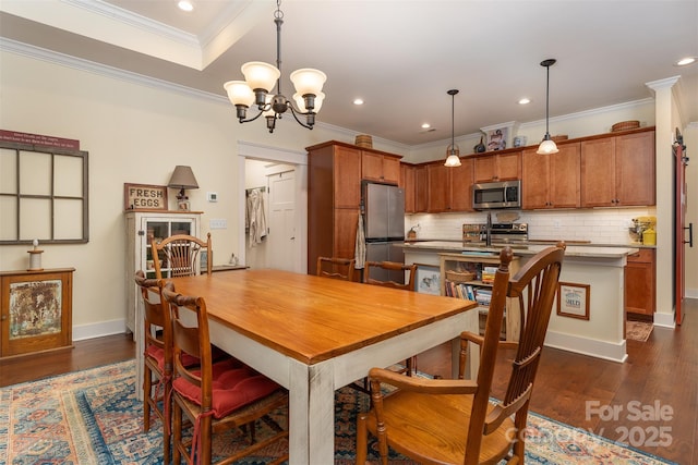 dining space featuring crown molding, dark hardwood / wood-style floors, and an inviting chandelier