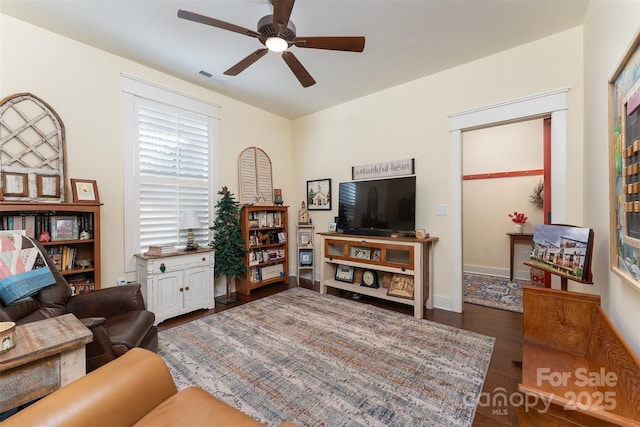 living room with dark hardwood / wood-style floors and ceiling fan