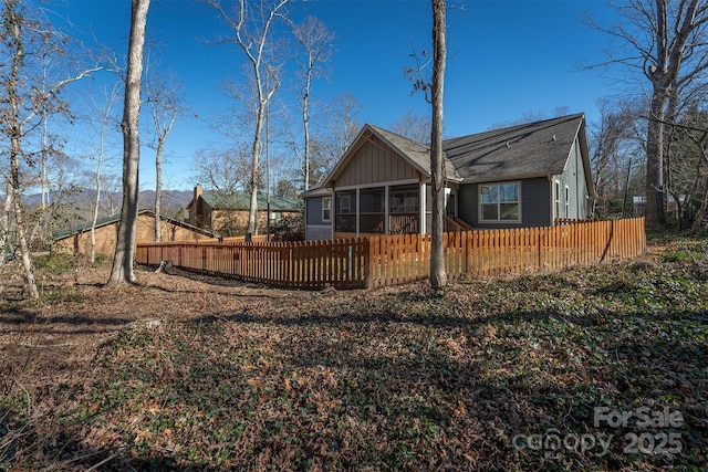 rear view of property featuring a sunroom