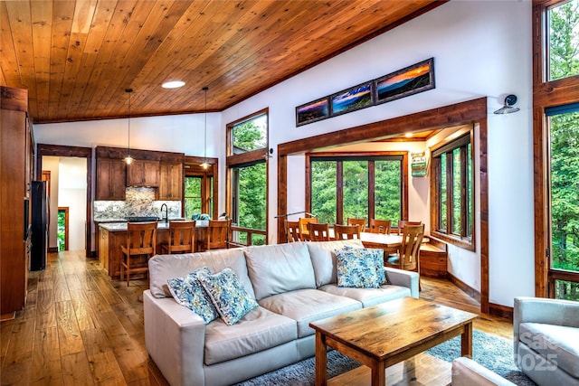 living room with high vaulted ceiling, light wood-type flooring, and wooden ceiling