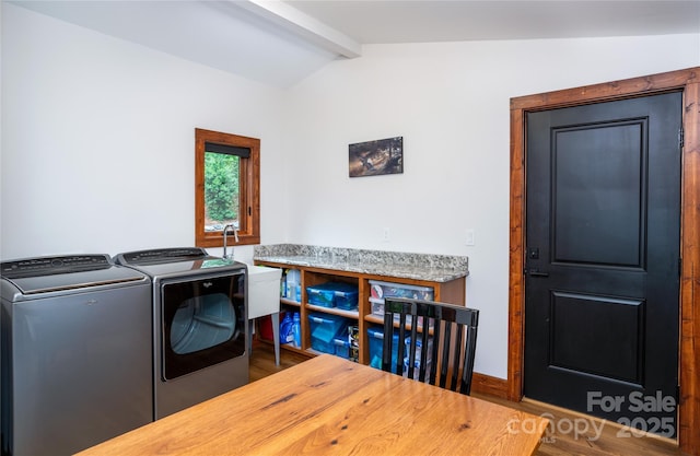 laundry area featuring washing machine and dryer and hardwood / wood-style floors