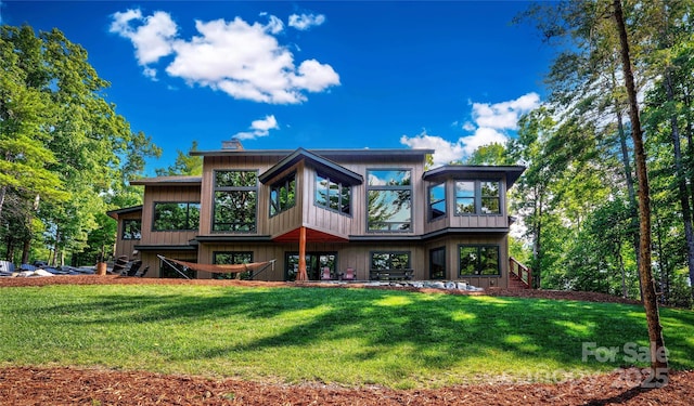 2126 Sycamore Dr, Nebo, NC 28761 - rear view of house featuring stairway, a yard, and a sunroom