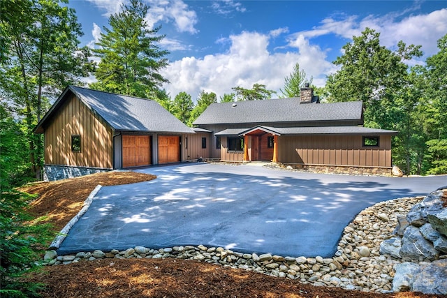 2126 Sycamore Dr, Nebo, NC 28761 - view of front of home with a chimney, a detached garage, asphalt driveway, and roof with shingles