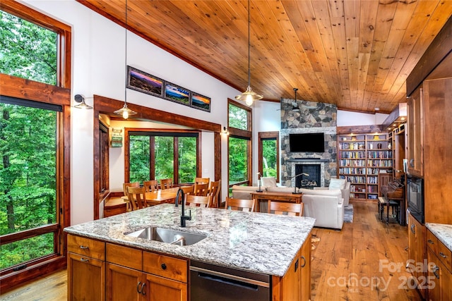 2126 Sycamore Dr, Nebo, NC 28761 - kitchen featuring a sink, stainless steel dishwasher, a fireplace, vaulted ceiling, and open floor plan