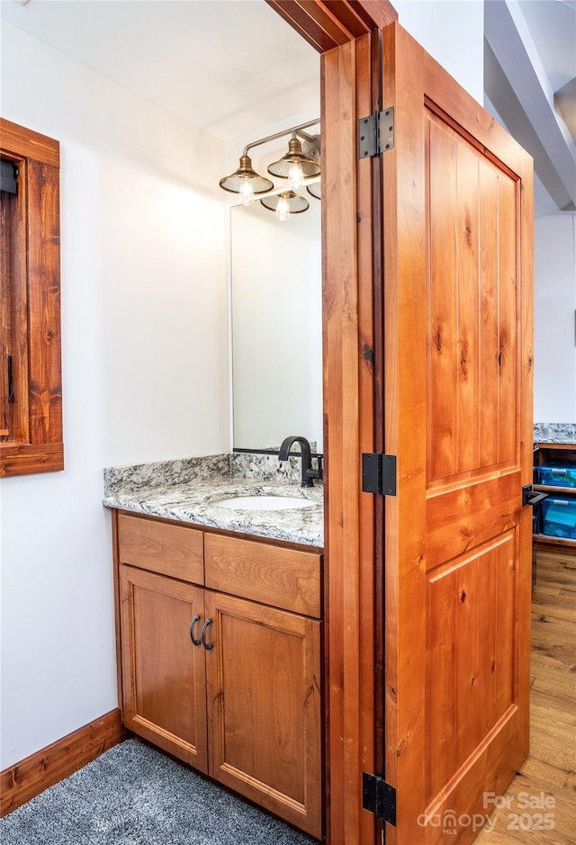 2126 Sycamore Dr, Nebo, NC 28761 - bathroom with vanity, baseboards, and wood finished floors