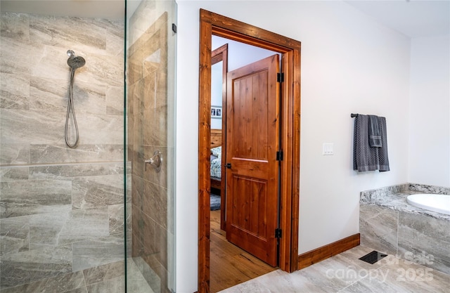 2126 Sycamore Dr, Nebo, NC 28761 - bathroom featuring tiled shower, a garden tub, and baseboards
