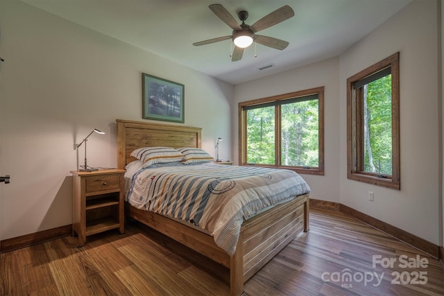 2126 Sycamore Dr, Nebo, NC 28761 - bedroom with baseboards, multiple windows, and wood finished floors