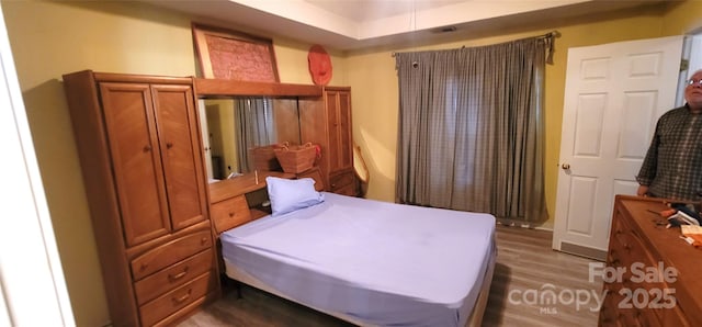 bedroom featuring dark wood-type flooring