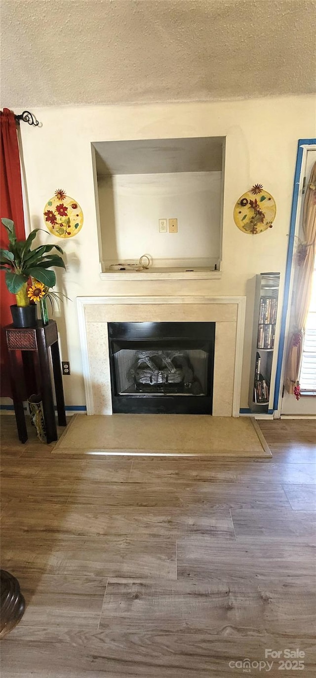 room details featuring hardwood / wood-style floors and a textured ceiling