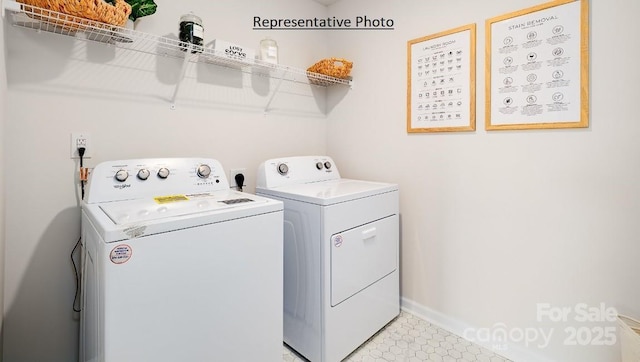 laundry area with separate washer and dryer and light tile patterned floors