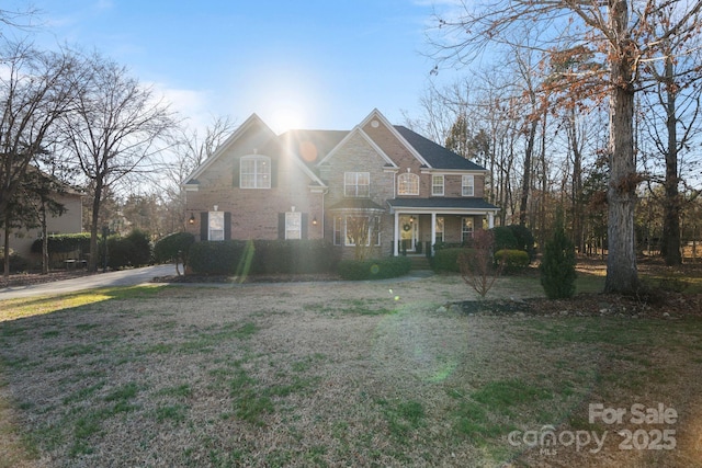 view of property featuring a front lawn