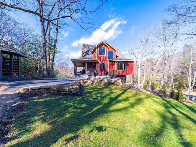 view of front of property with a front yard and a porch