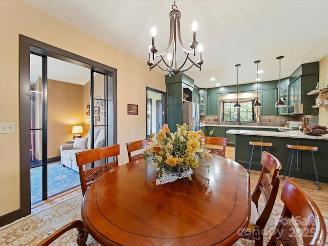 dining room with a chandelier and light hardwood / wood-style flooring