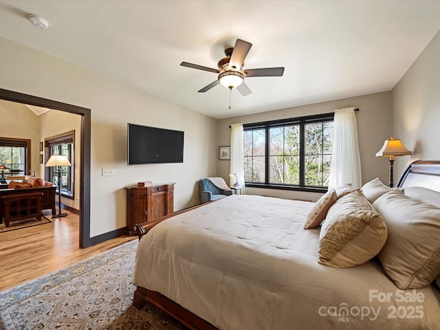 bedroom featuring lofted ceiling, hardwood / wood-style flooring, and ceiling fan