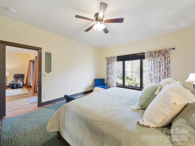 bedroom featuring hardwood / wood-style flooring and ceiling fan