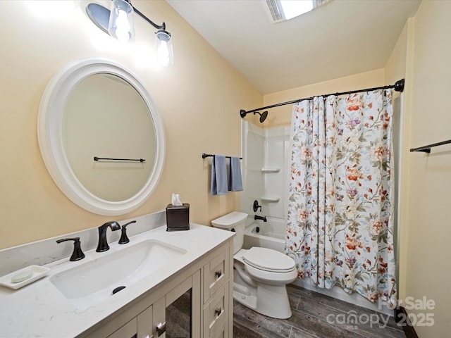 full bathroom featuring vanity, hardwood / wood-style floors, shower / bath combination with curtain, and toilet