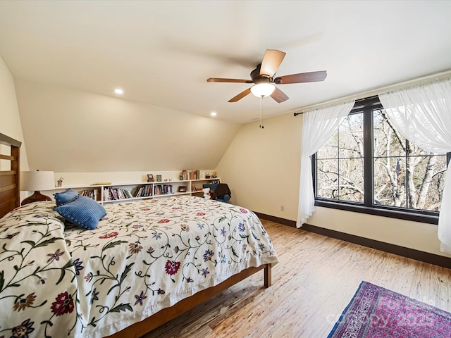 bedroom with vaulted ceiling, ceiling fan, and light hardwood / wood-style floors