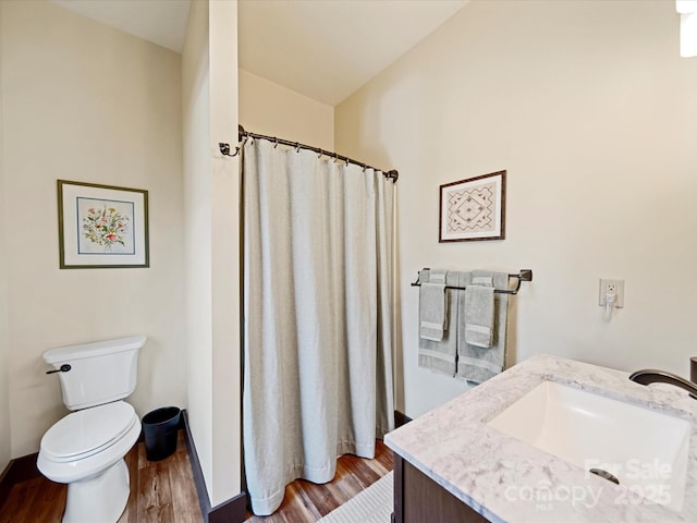 bathroom with hardwood / wood-style flooring, vanity, and toilet