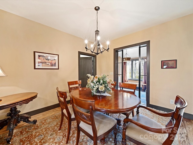 dining room with an inviting chandelier and wood-type flooring