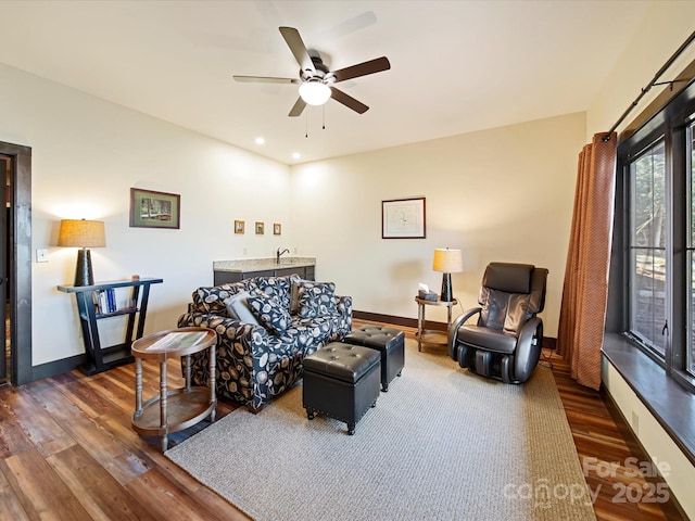 living room featuring ceiling fan, dark hardwood / wood-style flooring, and sink