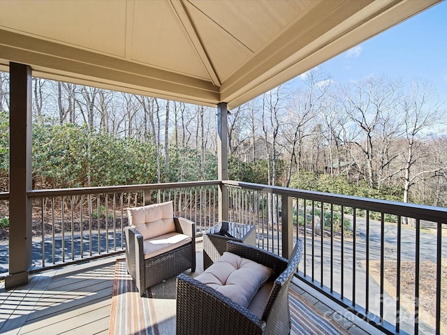 wooden terrace with an outdoor hangout area