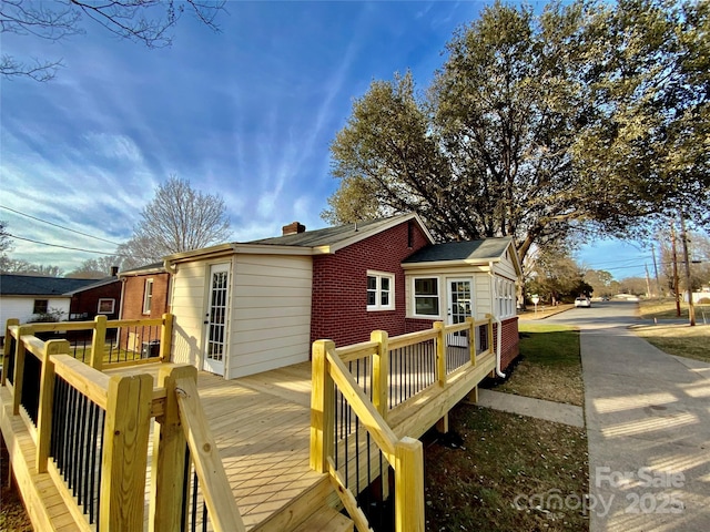 rear view of property featuring a wooden deck