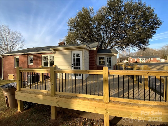 back of house featuring a wooden deck