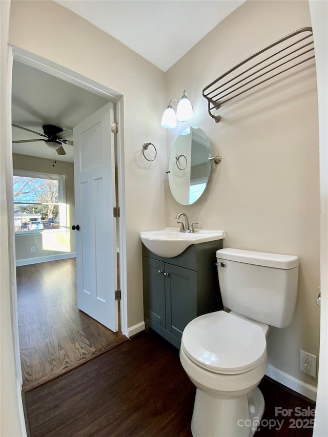 bathroom with vanity, hardwood / wood-style floors, toilet, and ceiling fan