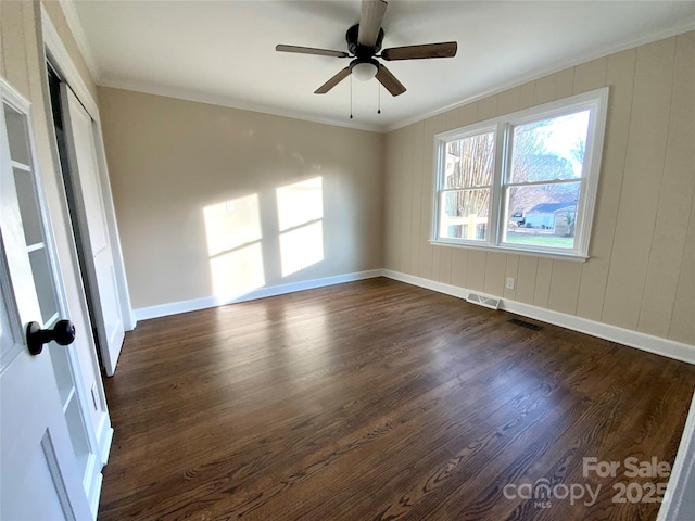 unfurnished room with ceiling fan, ornamental molding, and dark hardwood / wood-style flooring