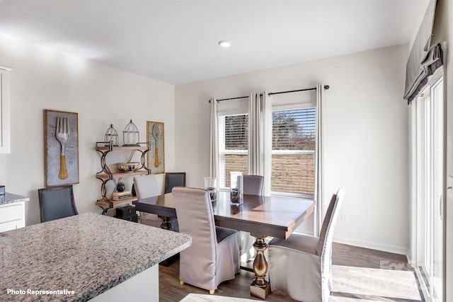 dining space with dark wood-type flooring